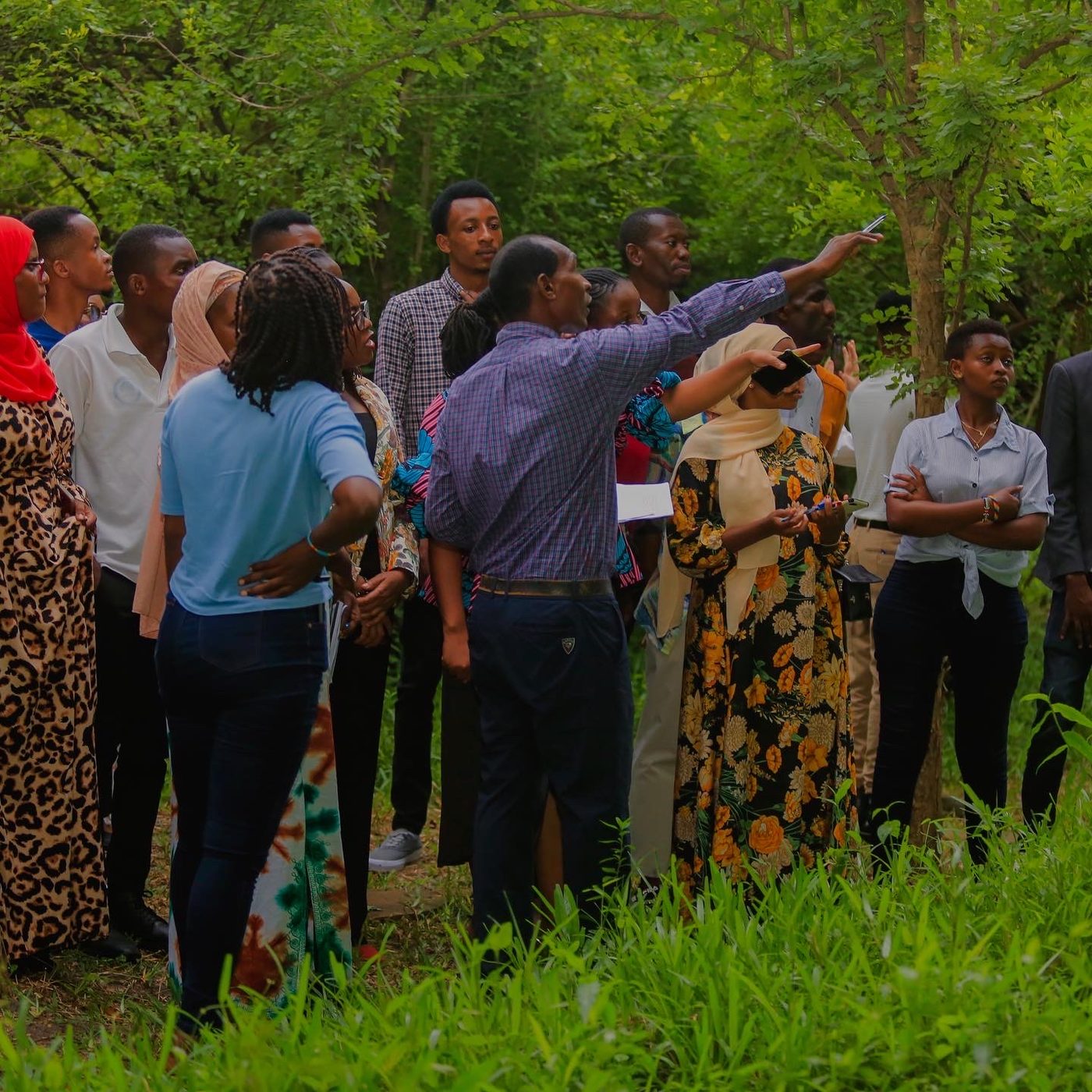 Community members and facilitators gathered outdoors during a field session