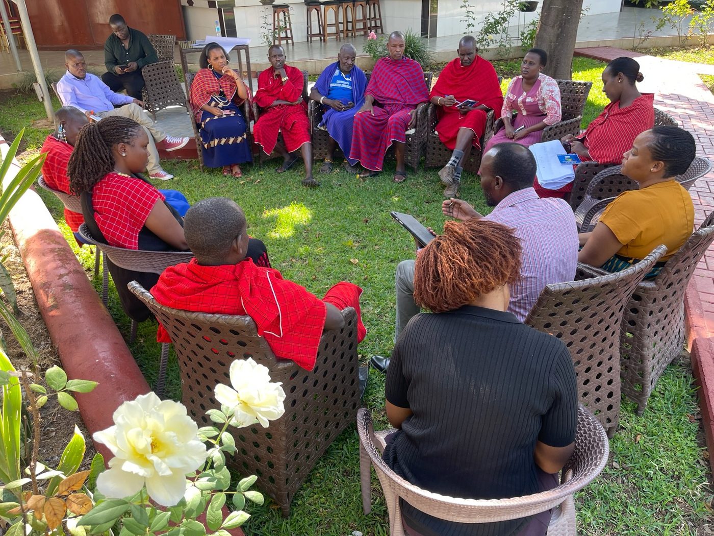 Community members seated in discussion outdoors